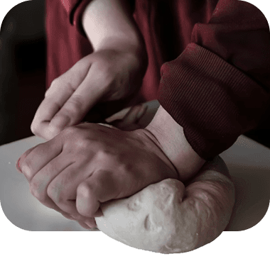 Hands kneading dough