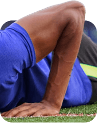Athlete in a plank position with hand and wrist on turf