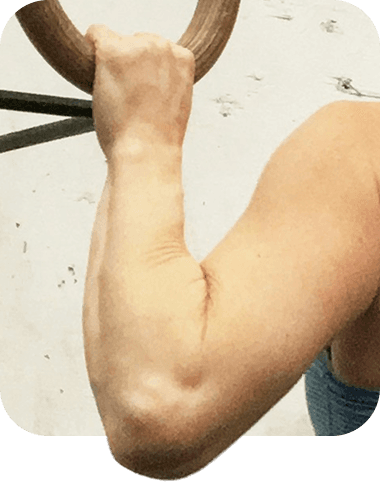 Forearm and hand gripping a gymnastic ring