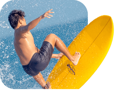 Surfer riding a wave on a yellow board