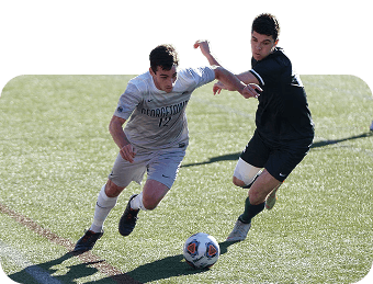 Soccer players competing for the ball on a turf field